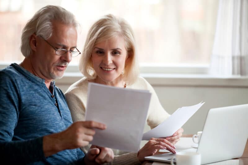 two people looking at papers